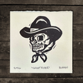 Black and white illustration of a skull wearing a cowboy hat
